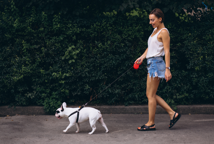 Woman walking with her pet dog
