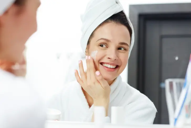 Person applying gentle moisturizer to face