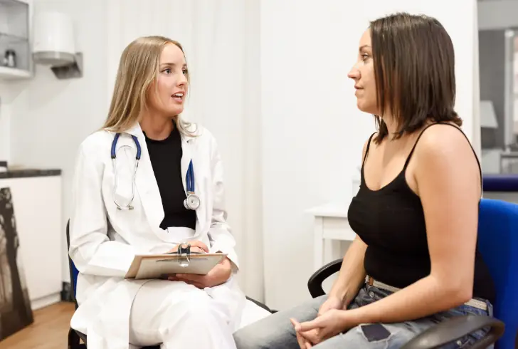 Female doctor talks with patient about sleep health