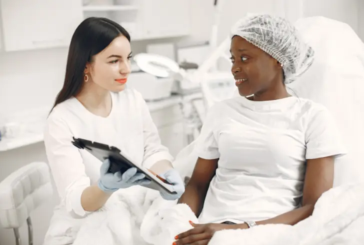 Kenyan woman consulting plastic surgeon