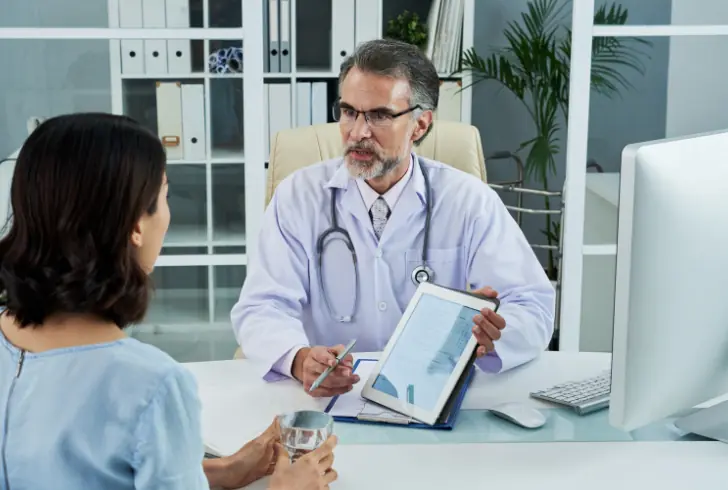 Doctor reviewing patient growth chart